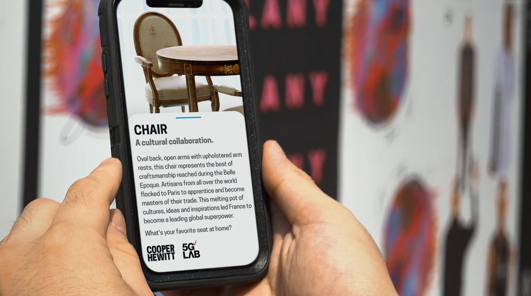 hands holding a mobile phone with a picture of a chair with a blurb showcasing a concept design. 