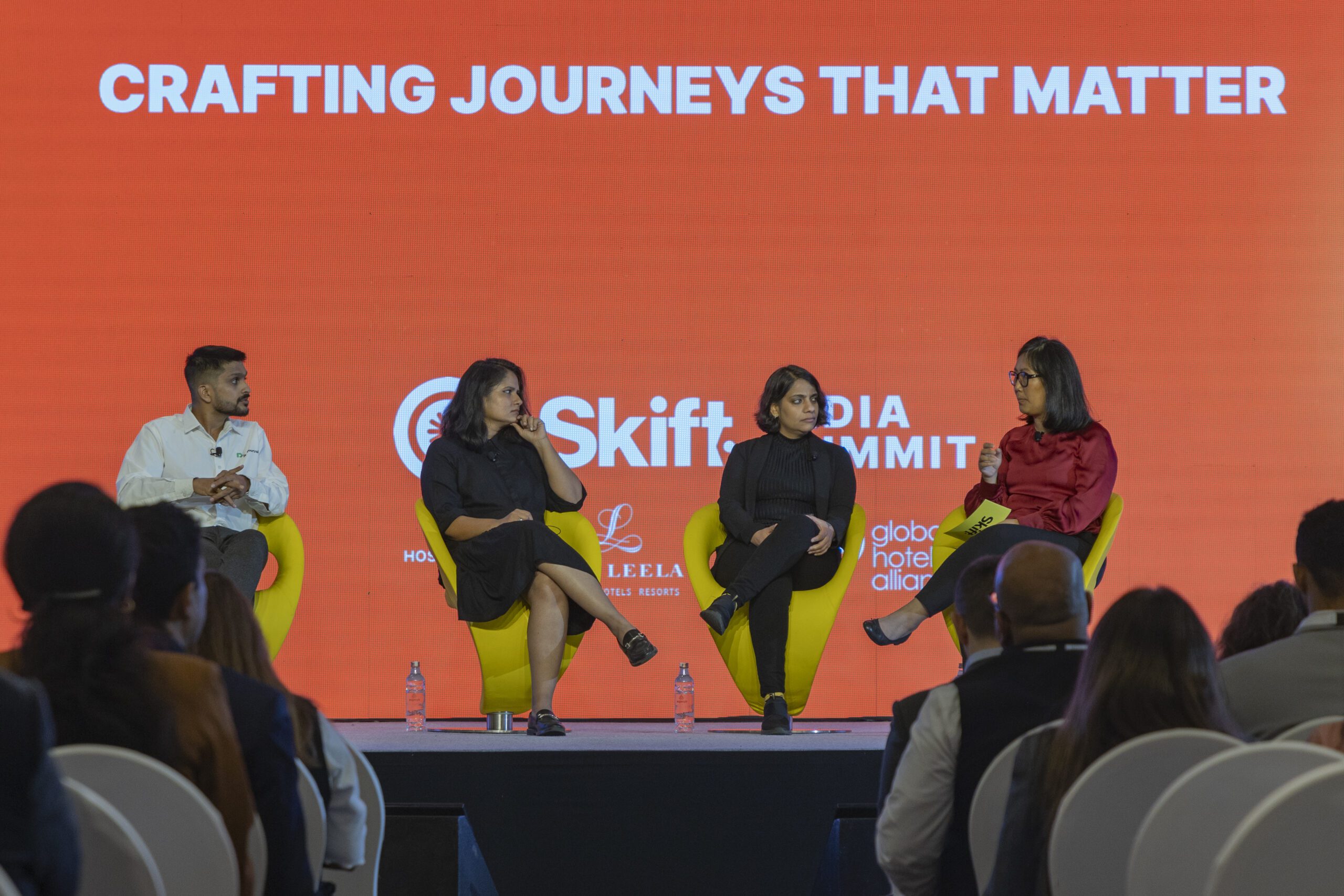 Four leaders on stage at a travel event in India