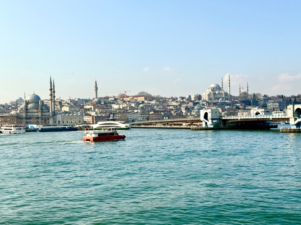 A scenic view of Istanbul’s waterfront featuring the Galata Bridge and the city's historic skyline captured during Skift 2025 Retreat